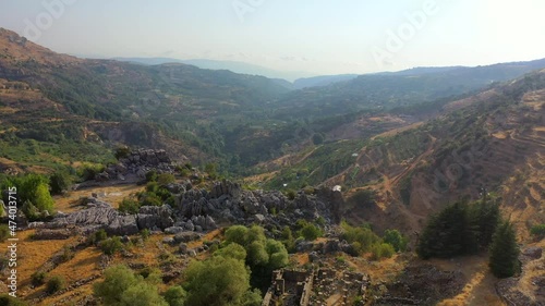 Aerial Upward Scenic Shot Of Mountains Against Sky, Drone Flying Forward Over Fallen Structure - Kfardebian, Lebanon photo