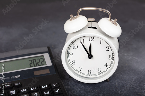 alarm clock and calculator. tax season and economy concept.
 photo