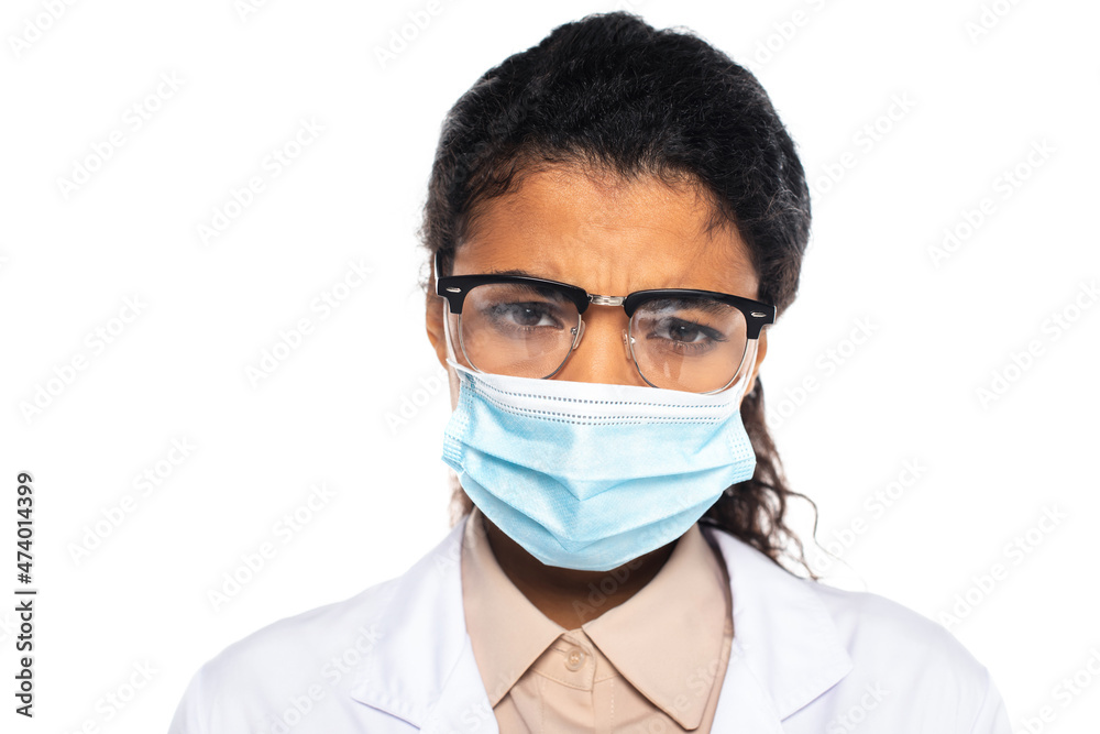 Sad african american doctor in eyeglasses and medical mask looking at camera isolated on white. Sad african american doctor in eyeglasses and medical mask looking at camera isolated on white.