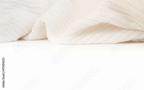 White knitted winter sweater on a white background, place for text