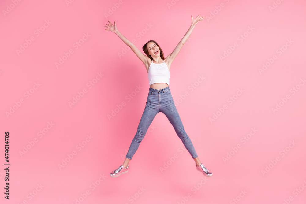 Full size photo of young excited lovely lady have fun jump up fly air isolated over pink color background Full size photo of young excited lovely lady have fun jump up fly air isolated over pink color background