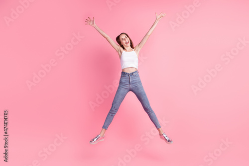 Full size photo of young excited lovely lady have fun jump up fly air isolated over pink color background