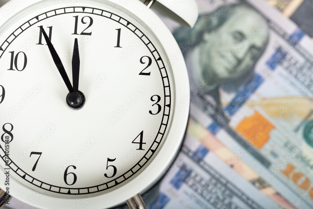 dollars and alarm clock. money and economy concept.
dollars and alarm clock. money and economy concept.