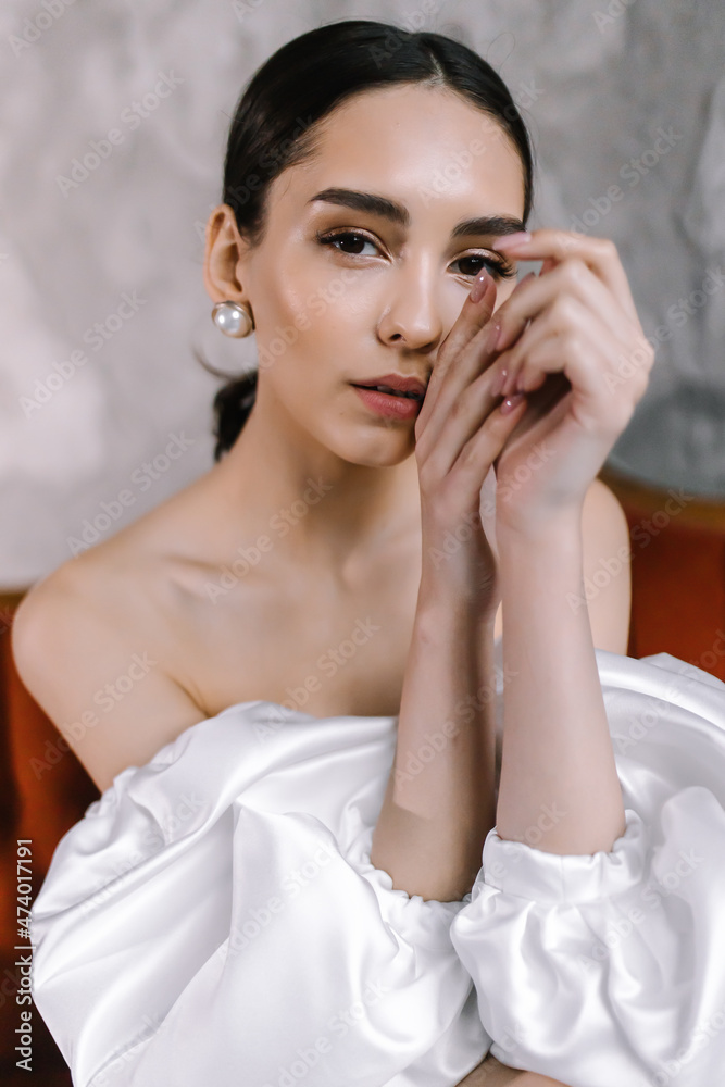 Young woman in white wedding dress Brunette model posing Portrait of a beautiful face Young woman in white wedding dress Brunette model posing Portrait of a beautiful face
