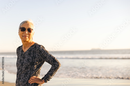 Smiling Senior Woman At Beach During Sunset