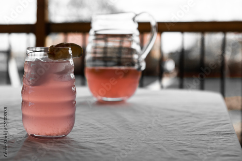 Close up of Pink lemonade with lemon wedge on table