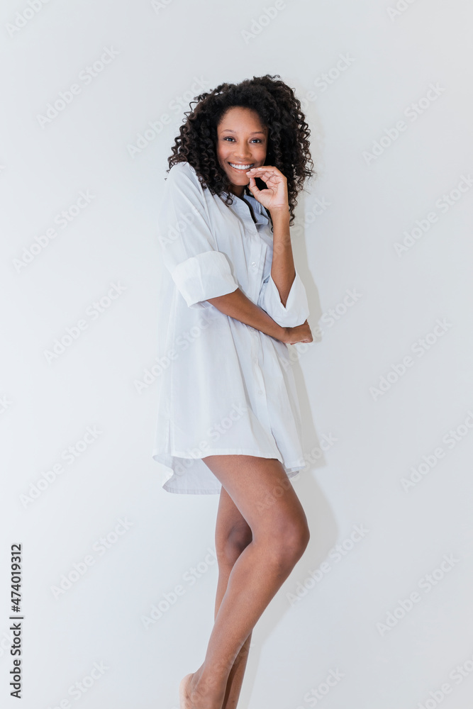 Woman with curly hair standing over white background Woman with curly hair standing over white background