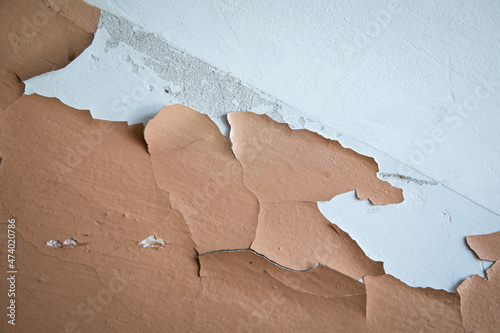 Brown paint on the wall with cracks and peels