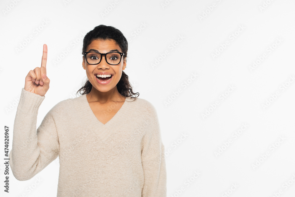 Excited african american woman in eyeglasses pointing with finger isolated on white. Excited african american woman in eyeglasses pointing with finger isolated on white.