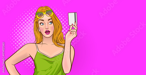 beautiful woman and fashion glasses presenting credit card in hand showing