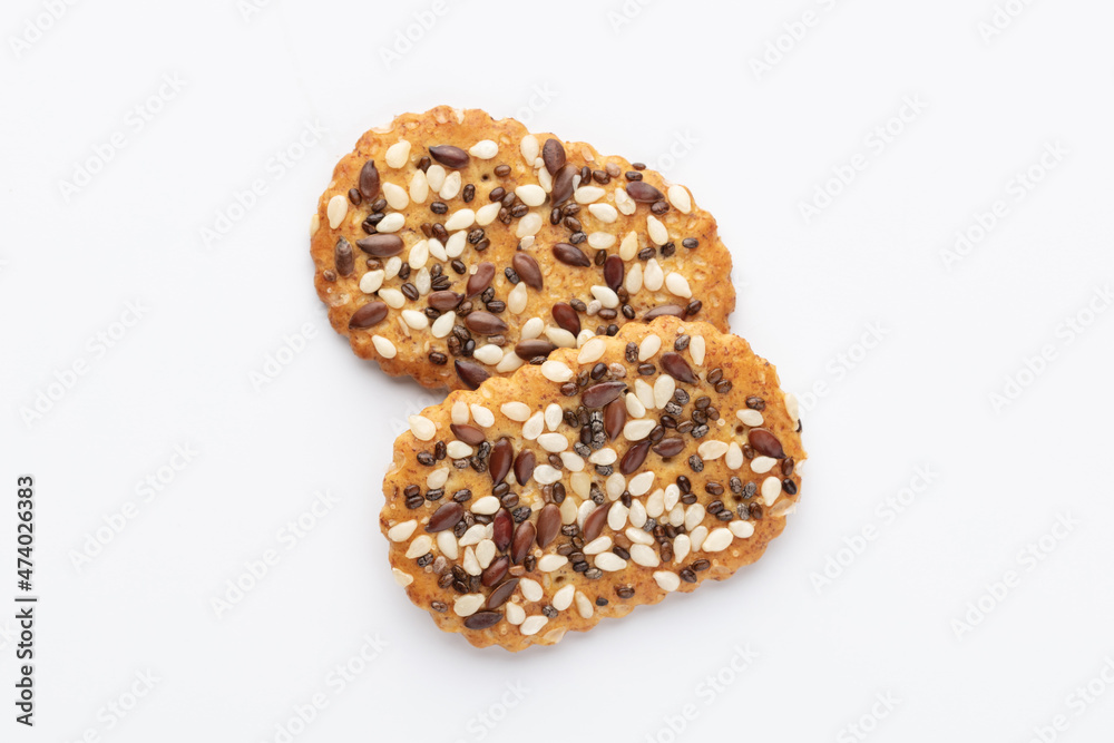 Tasty crackers with seeds on the white background.