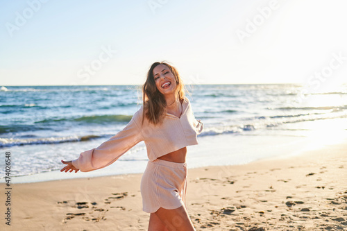 Woman in casual clothing enjoying at beach during sunny day