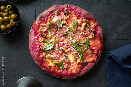 Purple colored rustic pizza photo