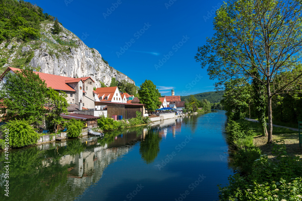 Germany, Bavaria, Essing, Altmuhl river and adjacent town in summer Germany, Bavaria, Essing, Altmuhl river and adjacent town in summer