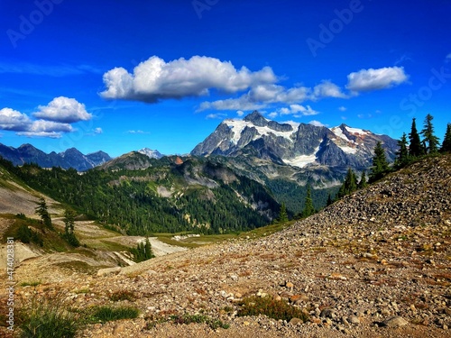 landscape of mount shuksan mountain with glaciers, snow, forest and blue sky