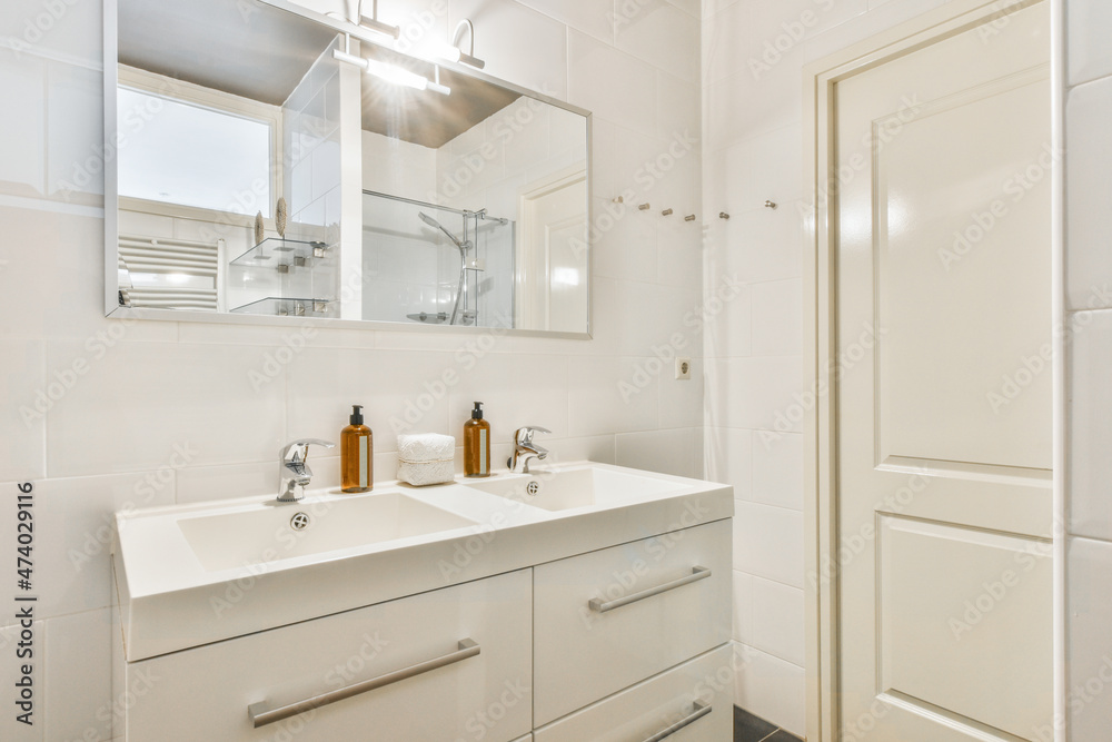Interior of white tiled simple bathroom Interior of white tiled simple bathroom