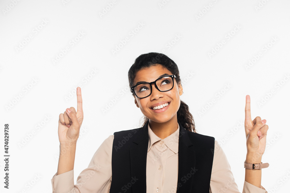 Cheerful african american businesswoman in eyeglasses pointing with fingers isolated on white. Cheerful african american businesswoman in eyeglasses pointing with fingers isolated on white.