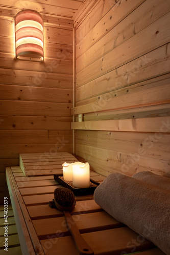 Interior of a small Finnish wooden sauna with sauna accessories.