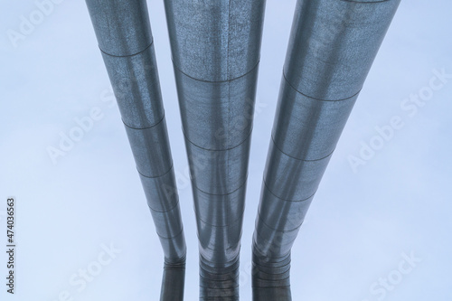Metal pipes. Stainless steel casing. Perspective view against the blue sky. Concept  gas pipeline, oil pipeline, fuel pipe, conduit.