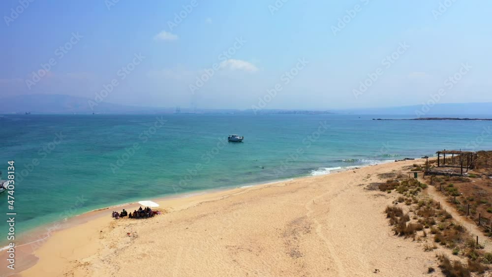 Aerial Beautiful Shot Of Nautical Vessel In Sea, Drone Flying Backwards Over Beach Landscape - Tripoli, Lebanon Aerial Beautiful Shot Of Nautical Vessel In Sea, Drone Flying Backwards Over Beach Landscape - Tripoli, Lebanon