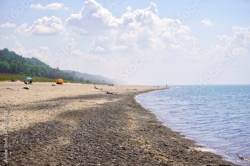 Indiana Dunes National Park Kemil Beach and Dunbar Beach area. Sunbathers on a rocky beach of Lake Michigan. 