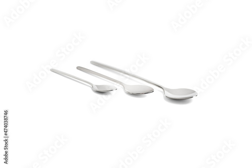 Clean shiny metal spoon isolated on white. Stainless steel small kitchen dessert teaspoon cut close up. Tablespoon. Kitchen utensils concept. Set of realistic spoons from different points of view.