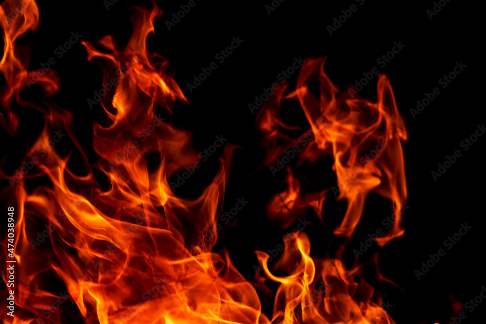 Abstract flame, fire flame texture, background. Blurred moving tongues of fire on a dark background. Abstract flame, fire flame texture, background. Blurred moving tongues of fire on a dark background.