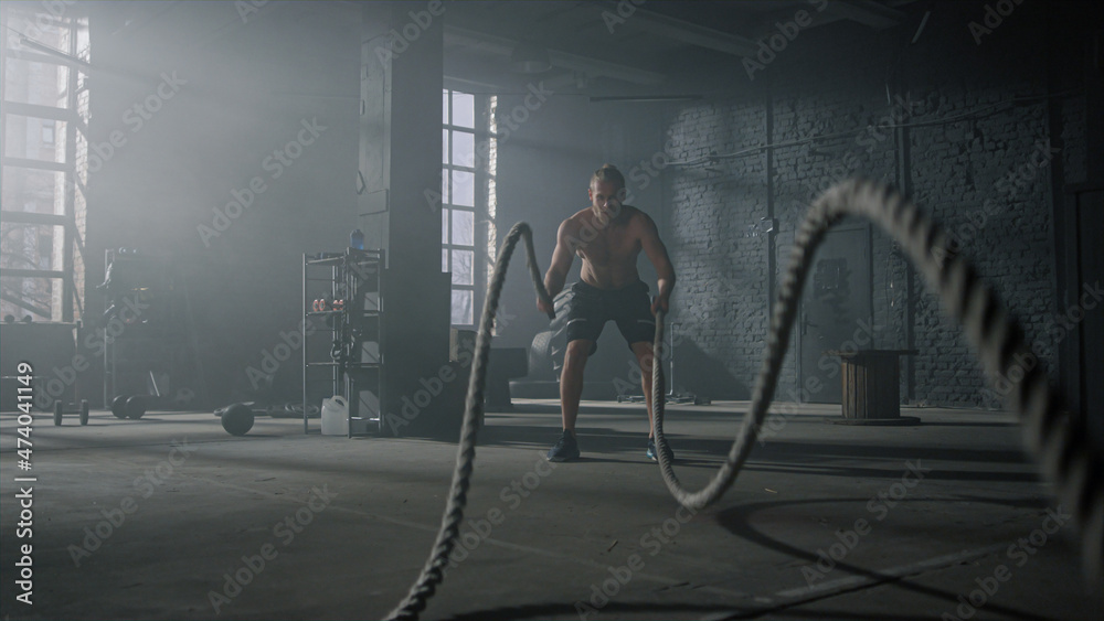 Картината върху платно Man practicing exercise with battle ropes