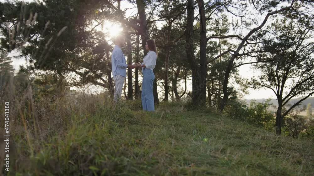 Close-up of man and a wooman that joining hands together on nature background. Beautiful romantic moment between two lovers Close-up of man and a wooman that joining hands together on nature background. Beautiful romantic moment between two lovers