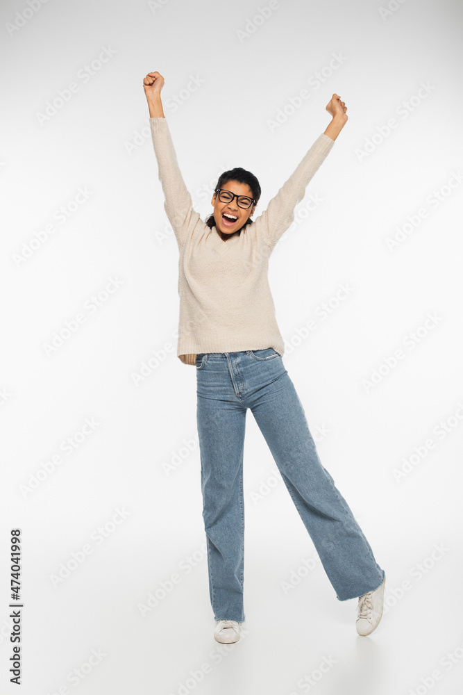 Excited african american woman in eyeglasses on white background. Excited african american woman in eyeglasses on white background.