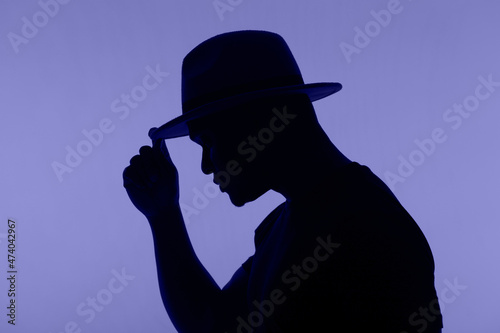 Man silhouette pose with hat on very peri colour of 2022 background