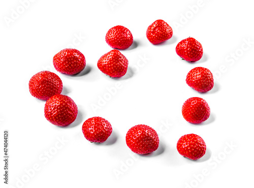 Heart shape made of strawberries. white background