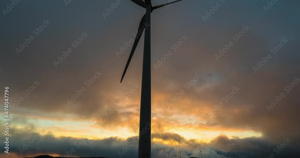 Lockdown Time Lapse Shot Of Dramatic Sky Moving Over Spinning Windmills During Sunset - Port Hardy, Canada Lockdown Time Lapse Shot Of Dramatic Sky Moving Over Spinning Windmills During Sunset - Port Hardy, Canada