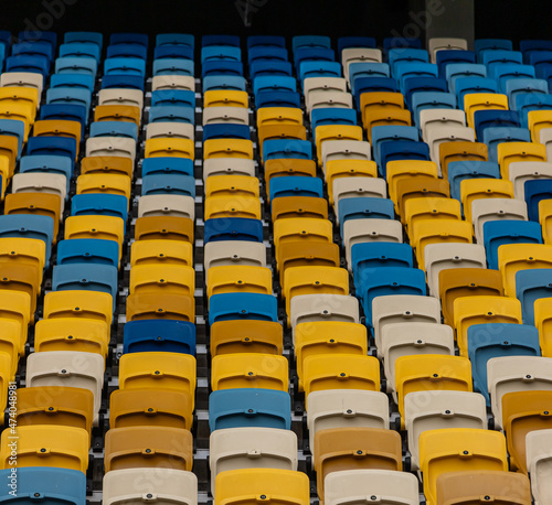 empty colorful seats on tribunes of stadium photo