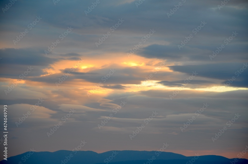 Altocumulus lenticularis over Adriatic Sea. Rare Lenticular cloud Altocumulus lenticularis on top of the Island Cres in Kvarner gulf. Altocumulus lenticularis over Adriatic Sea. Rare Lenticular cloud Altocumulus lenticularis on top of the Island Cres in Kvarner gulf.