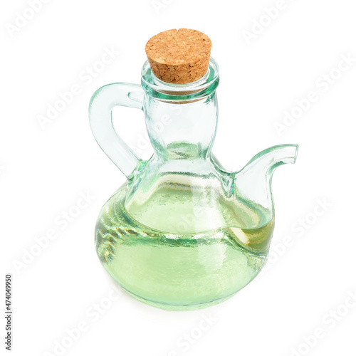 Glass jug with vegetable oil isolated on a white .