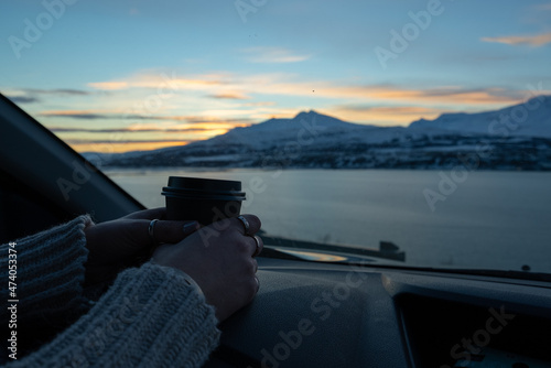 woman watching the sunset in cozy car with mountain landscape