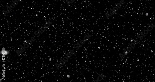 High-quality motion animation of repeated snow falling on a black background. Falling snow, seamless loopable background footage. Christmas snowflakes swirl and fall slowly against a black background
