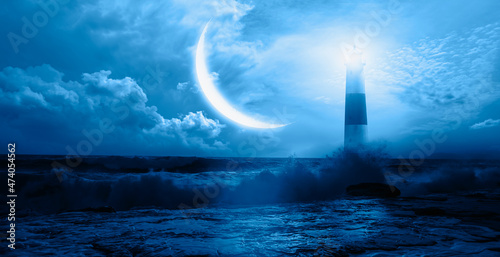 Night sky with crescent in the clouds, on the foreground lighthouse "Elements of this image furnished by NASA