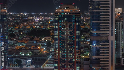Glowing windows and towers and villa houses on a background aerial night timelapse  Dubai  United Arab Emirates