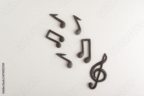 Chaotically arranged treble clef and notes on white background. Music symbol. Theme music.