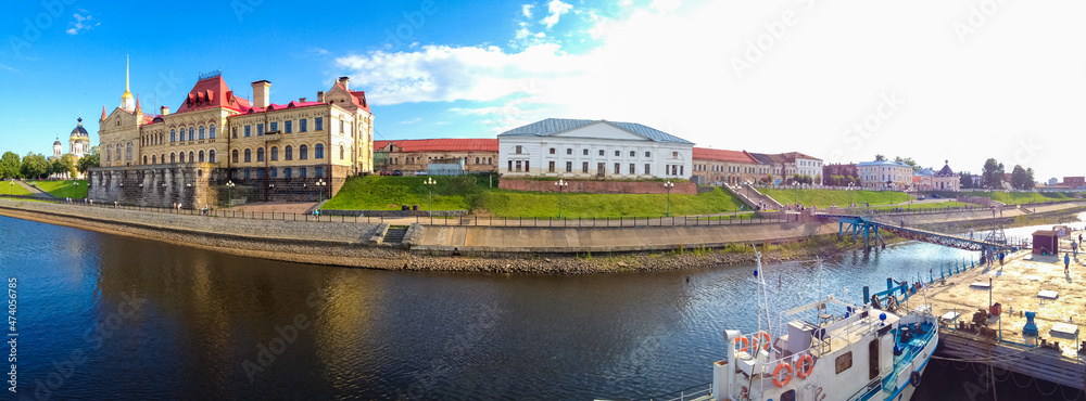 Volzhskaya embankment in Rybinsk, Russia, panoramic view. Waterfront near building of former Grain Exchange or building of Rybinsk State Historical. Transfiguration Cathedral