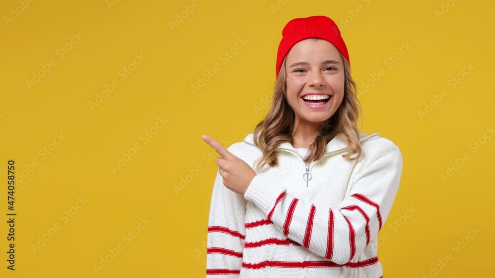 Excited promoter young girl teen student wears striped white shirt hat point finger hands aside on workspace copy space mockup promo commercial area isolated on plain yellow background studio portrait Excited promoter young girl teen student wears striped white shirt hat point finger hands aside on workspace copy space mockup promo commercial area isolated on plain yellow background studio portrait