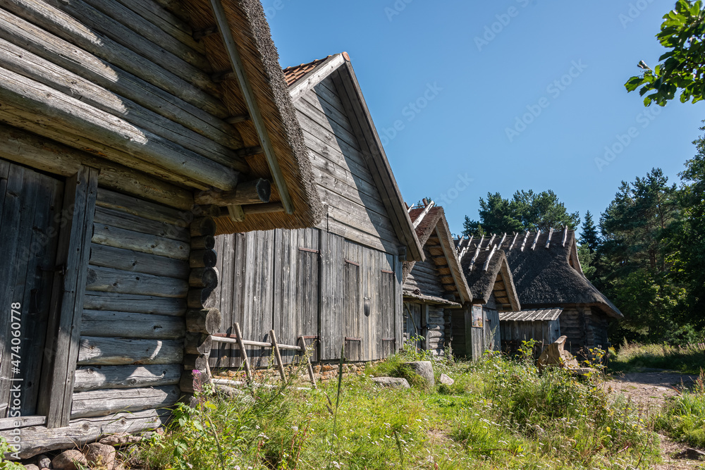 Idyllic wooden historic houses with thatched roof in Altja fishing village, northern Estonia
