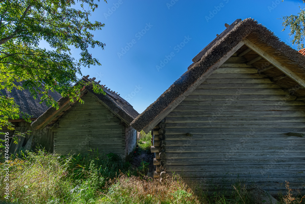 Idyllic wooden historic houses with thatched roof in Altja fishing village, northern Estonia Idyllic wooden historic houses with thatched roof in Altja fishing village, northern Estonia