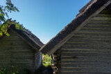Idyllic wooden historic houses with thatched roof in Altja fishing village, northern Estonia