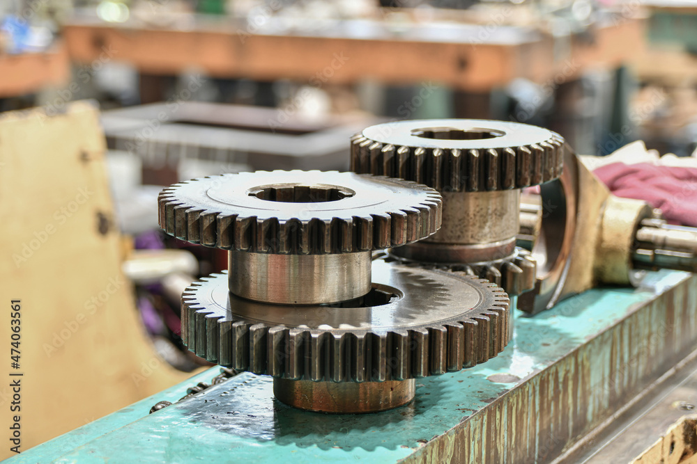 Divider discs and gears for changing the speeds of a metal-cutting machine being repaired in a workshop. Divider discs and gears for changing the speeds of a metal-cutting machine being repaired in a workshop.