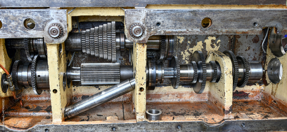 Gears and indexing discs inside the gearbox of a metal cutting machine.