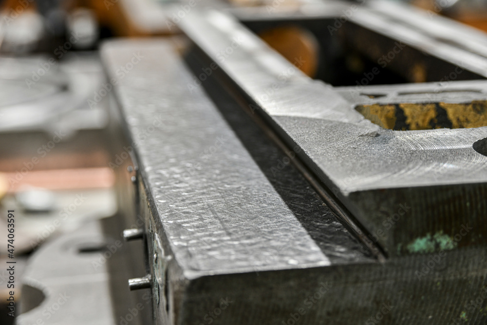 Close-up of the scraped surface of the guide bed of a metalworking machine. Mechanical equipment repair shop. Close-up of the scraped surface of the guide bed of a metalworking machine. Mechanical equipment repair shop.