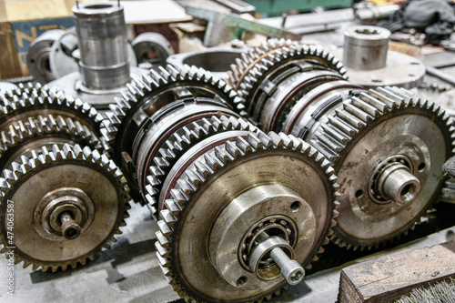 Disassembled gearbox with clutch discs of a metalworking machine. Mechanical equipment repair shop.